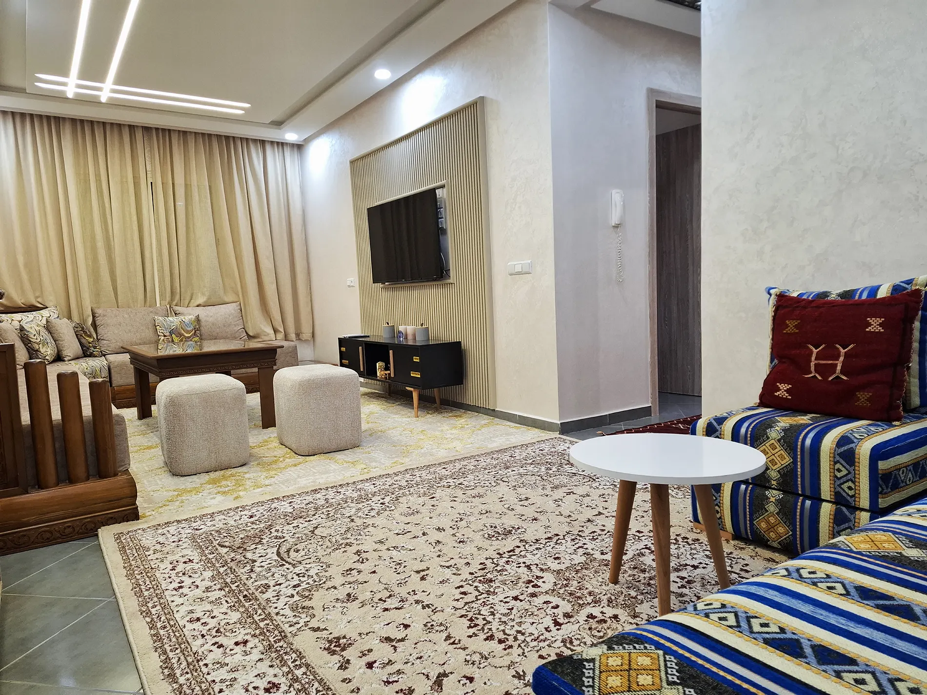 Living room with natural light and large coffee table.